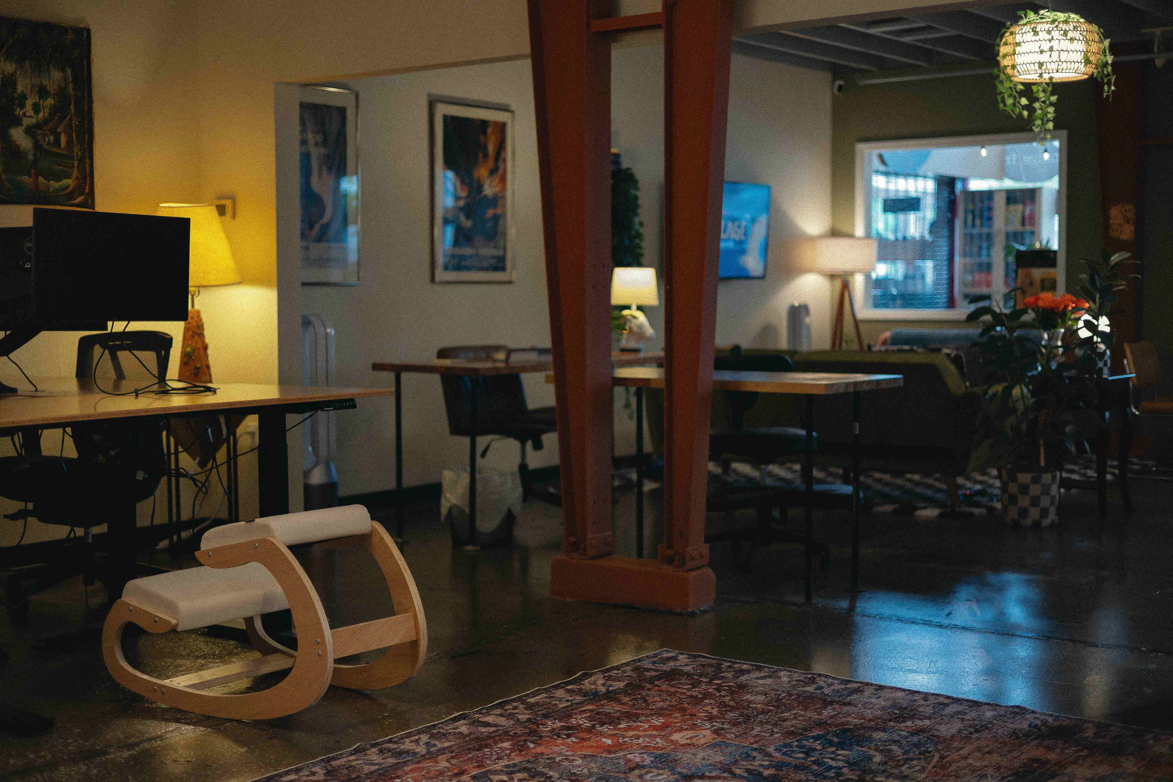 Villageco.work main workspace with desks and warm lighting